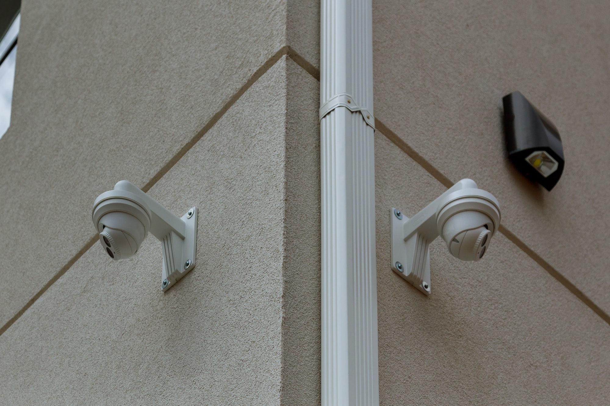 two white security cameras CCTV Camera on the white wall